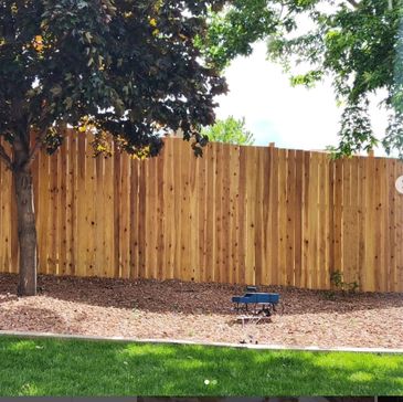 A privacy fence bordering a small xeriscape feature. 