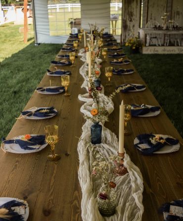 Rustic outdoor dining table with elegant decorations.