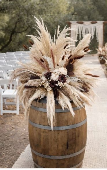 Rustic flower arrangement on a wooden barrel.