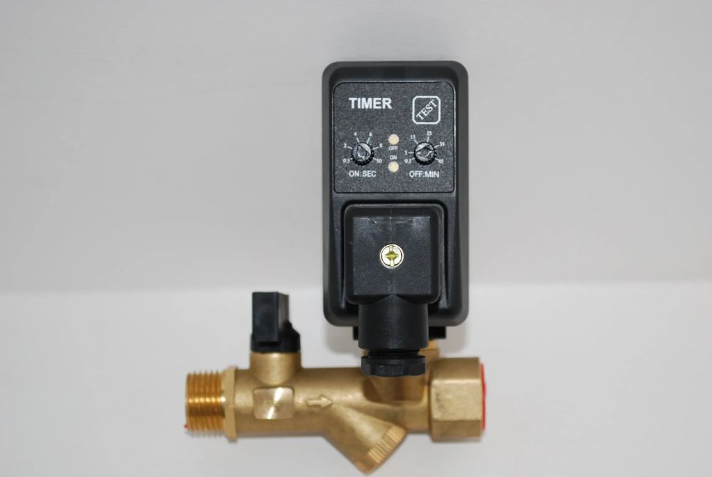 A brass valve with a black timer control unit attached on top.