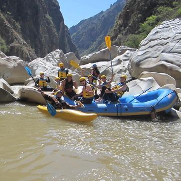 Group rafting in a rocky canyon river.