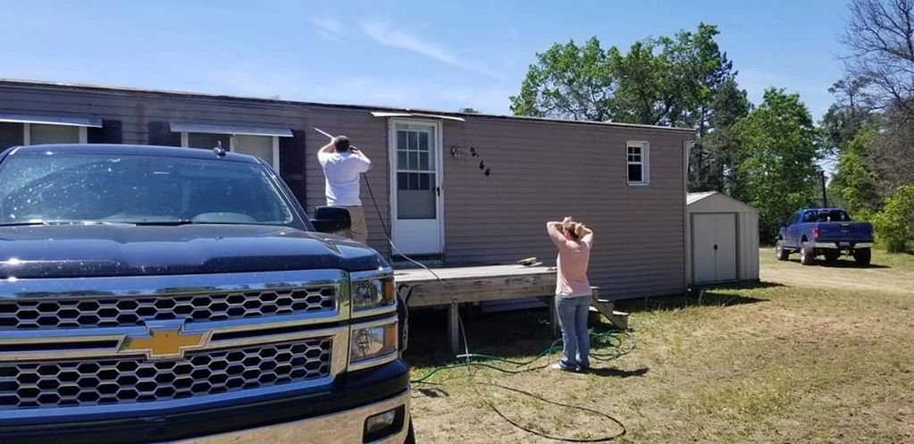 William and Vanessa power washing the camp