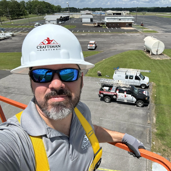 Chris Cole, owner of Craftsman Roofing, wearing a Craftsman Roofing hard hat.