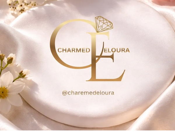 Elegant logo for Charmed Eloura with gold lettering and floral background.