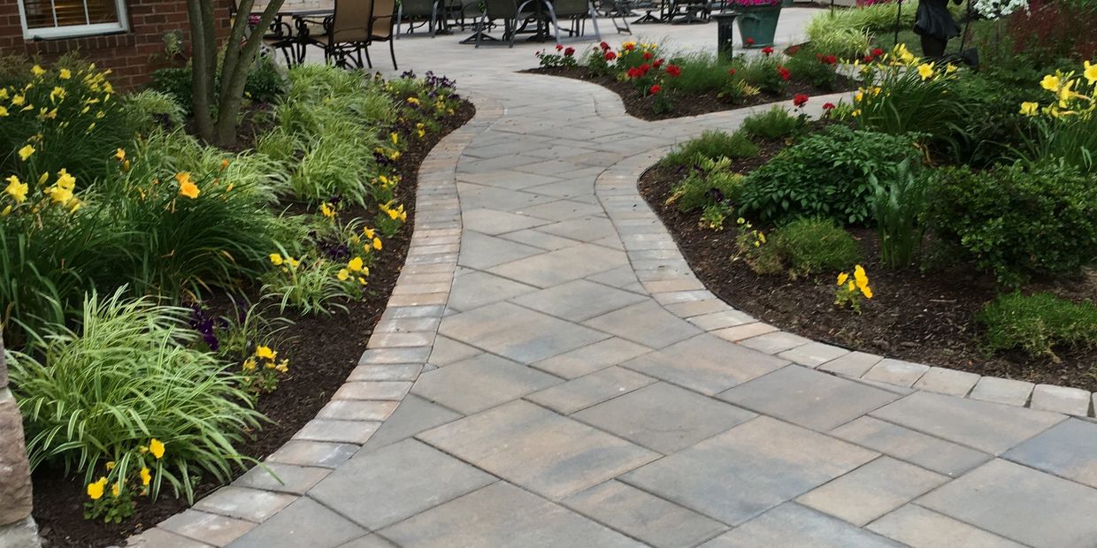 Paver walkway and paver patio with landscaping