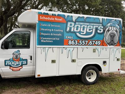 Service truck for Rogers Air Conditioning with contact details and services listed.
