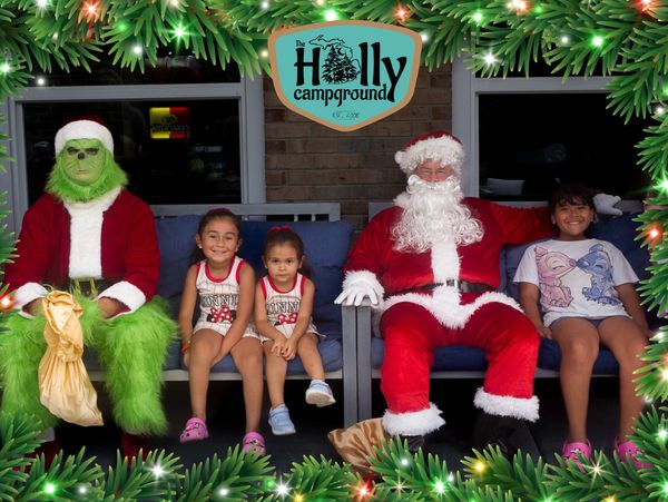 A family sitting with Santa Claus and the Grinch