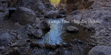 A rocky gorge hike with a stream flowing through, captioned 'leg day deluxe'.