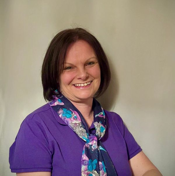 Photo of female company owner smiling and looking friendly
