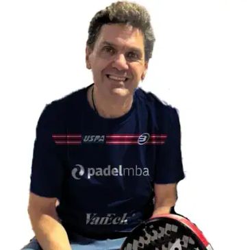 Man smiling with a paddle tennis racket.