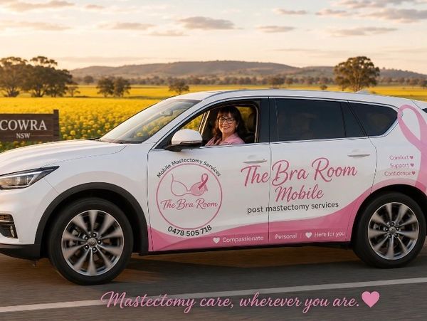 A woman drives a car promoting mobile post-mastectomy services.