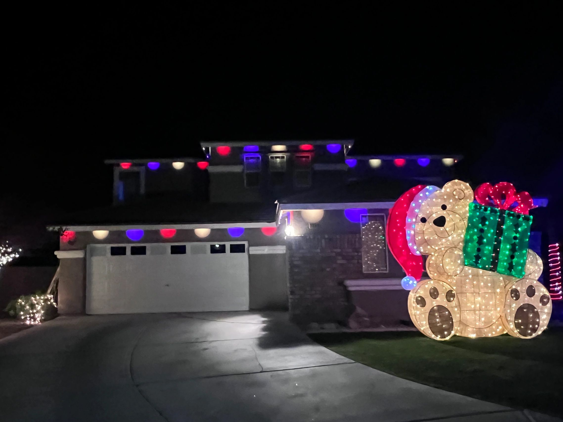 House decorated with vibrant Govee permanent outdoor lighting, installed as part of a professional holiday lighting referral and discount referral program by Santa’s Lights. Smart RGB lights enhance curb appeal and seasonal charm, showcasing expert installation and seamless integration for year-round architectural illumination. 