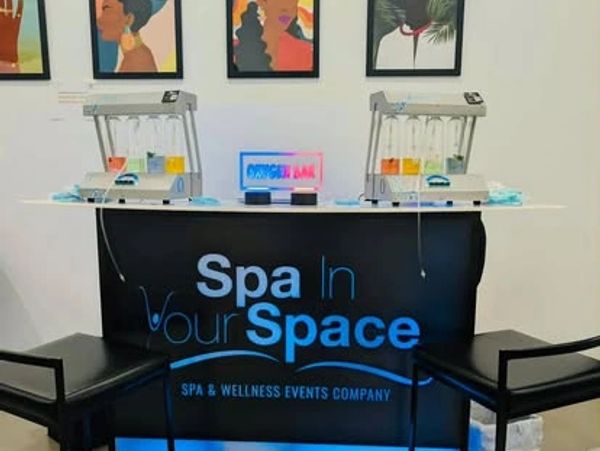 Spa In Your Space wellness event setup with chairs and skincare equipment.