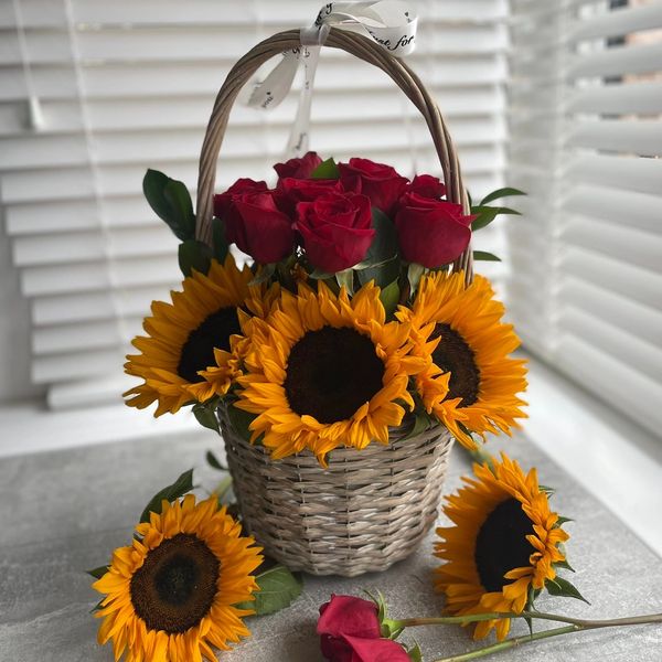 Premium basket of red roes and sunflowers.