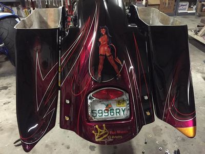 Little Devil Custom painted Fatboy Lo. Fiberglass fabricated custom saddle bags and fender.