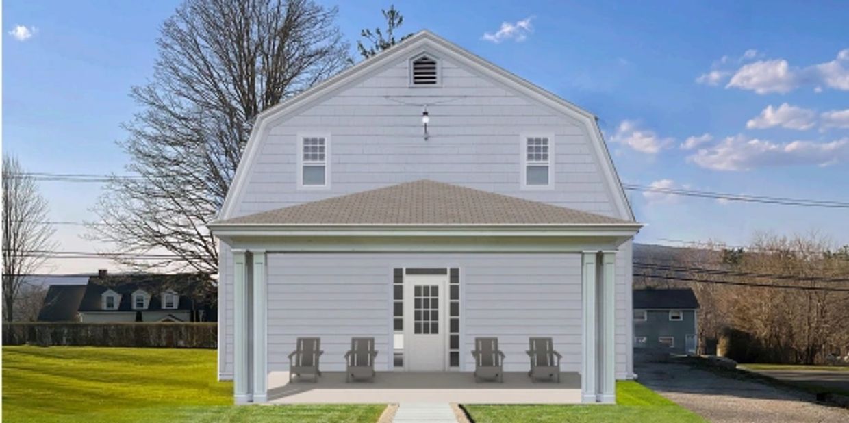 White house with front porch and four chairs under a clear sky.