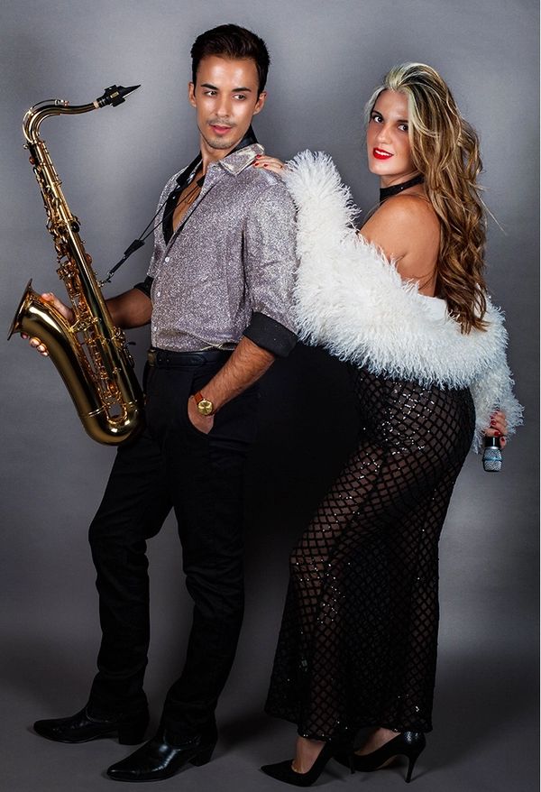 Stella & Angel portrait: luxury vocalist–DJ–sax duo with signature couture style.