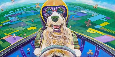 A dog wearing aviator goggles and helmet flying a plane.