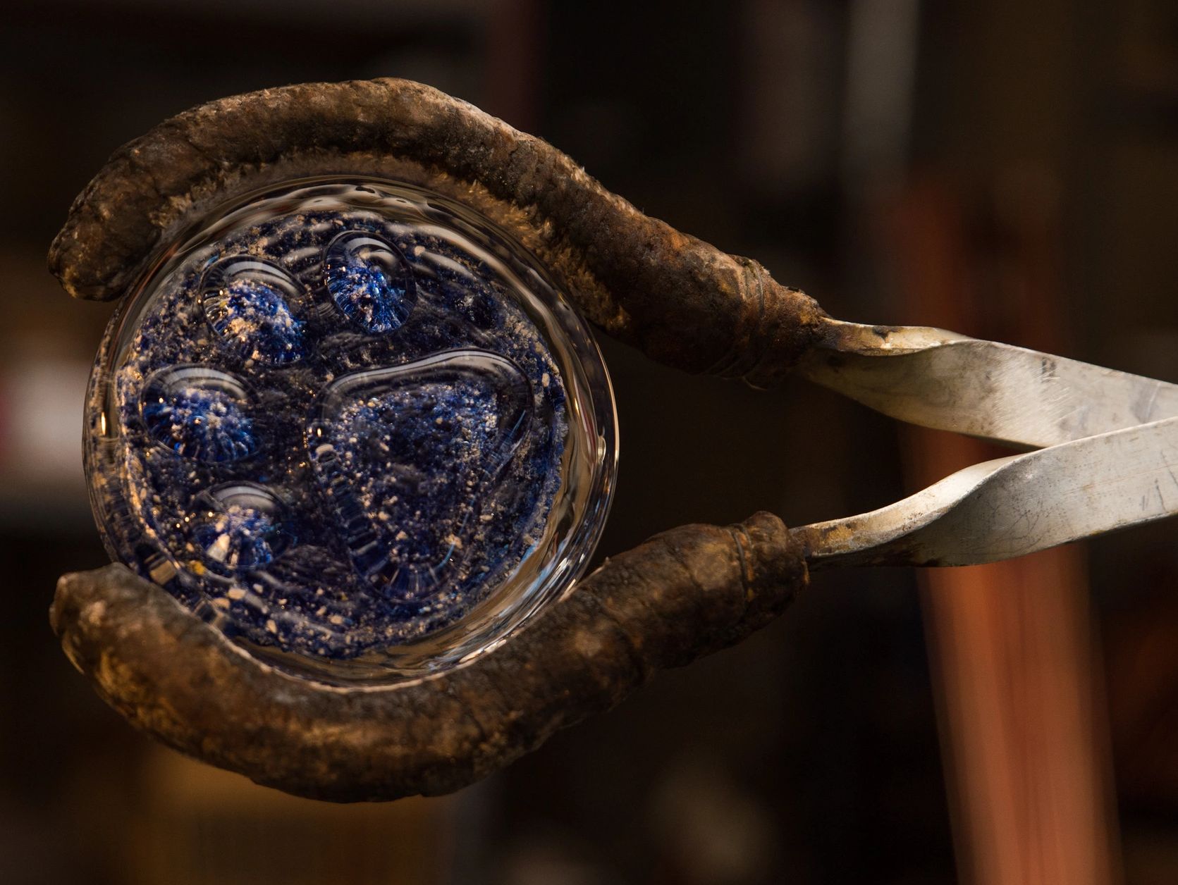 Close-up of a glassblowing process with molten glass.