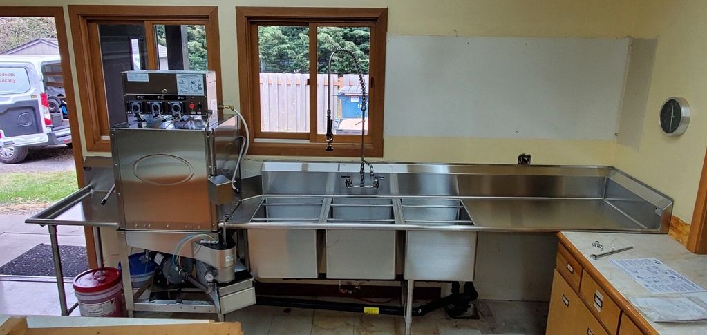 Commercial kitchen setup project at Orcas Center, Eastsound WA: dishwasher, table, and sink