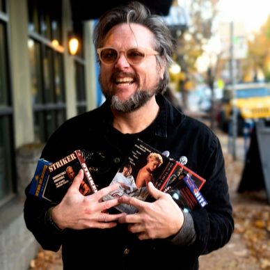 Michael and an armful of VHS...es