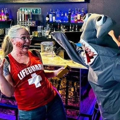 Lori "fighting" our shark mascot from the Ladies V Sharks comedy show where we riffed shark themed h