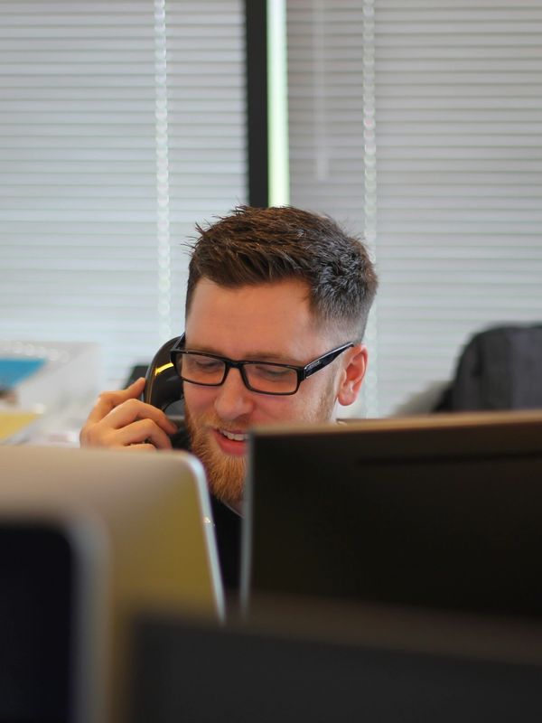 a man talking on the phone in an office