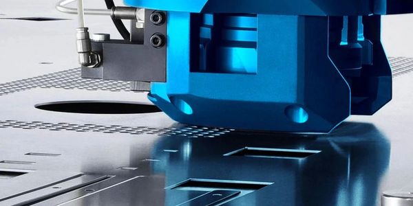 Close-up of a metal cutting machine working on a sheet.