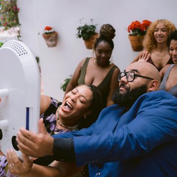 Guest interacting with roaming digital photo booth machine