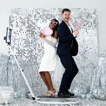 Capturing video of guest using 360 photo booth machine.