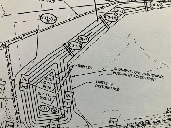 Section of a technical drawing showing sediment pond and disturbance limits.