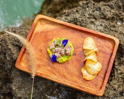 Ceviche and avocado salsa on a square wooden plate