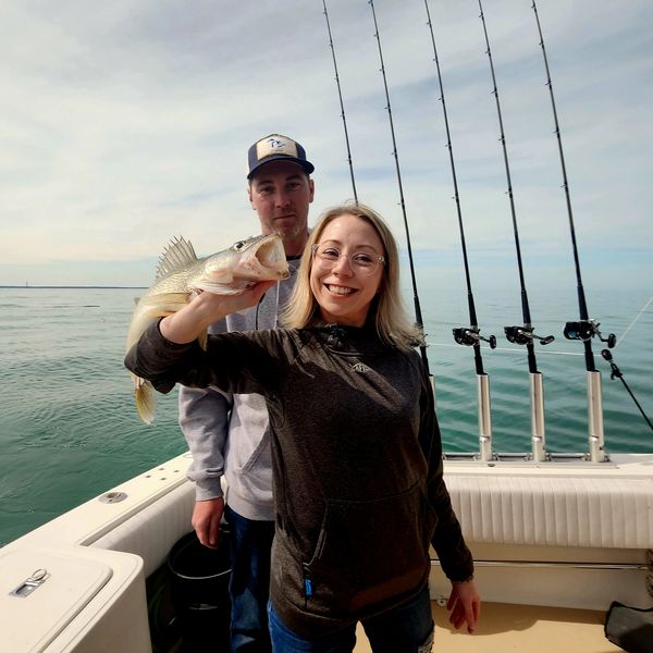 Captain Zach and girlfriend Lindsey holding up there eclipse walleye. 