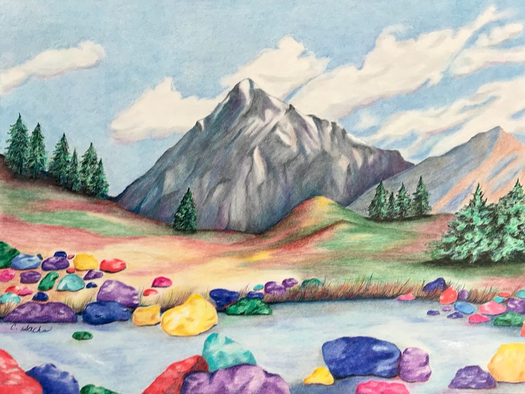 Colorful rocks near a mountain and pine trees.