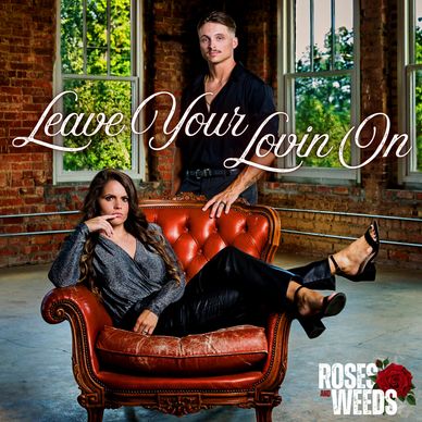 Couple poses stylishly with 'Leave Your Lovin On' text and Roses and Weeds logo.