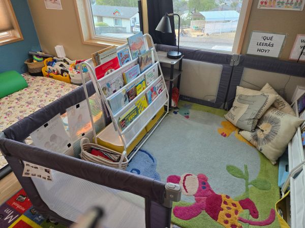 Colorful children's reading corner with books and pillows.
