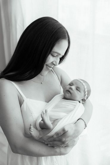Mother lovingly holding her newborn baby.