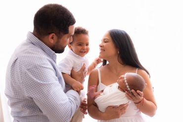 Happy family with two young children embracing.