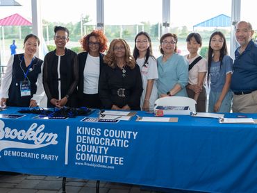 Group posing behind Kings County Democratic Party table.