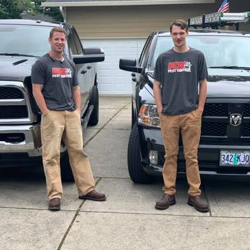 PDX Pest control technicians in front of service trucks