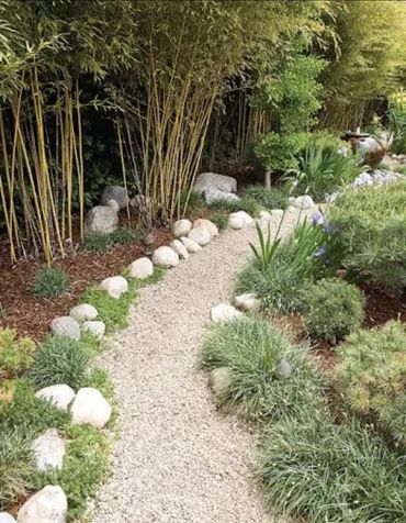 Front yard landscaping with clean rock border design and mulch in ann arbor michigan