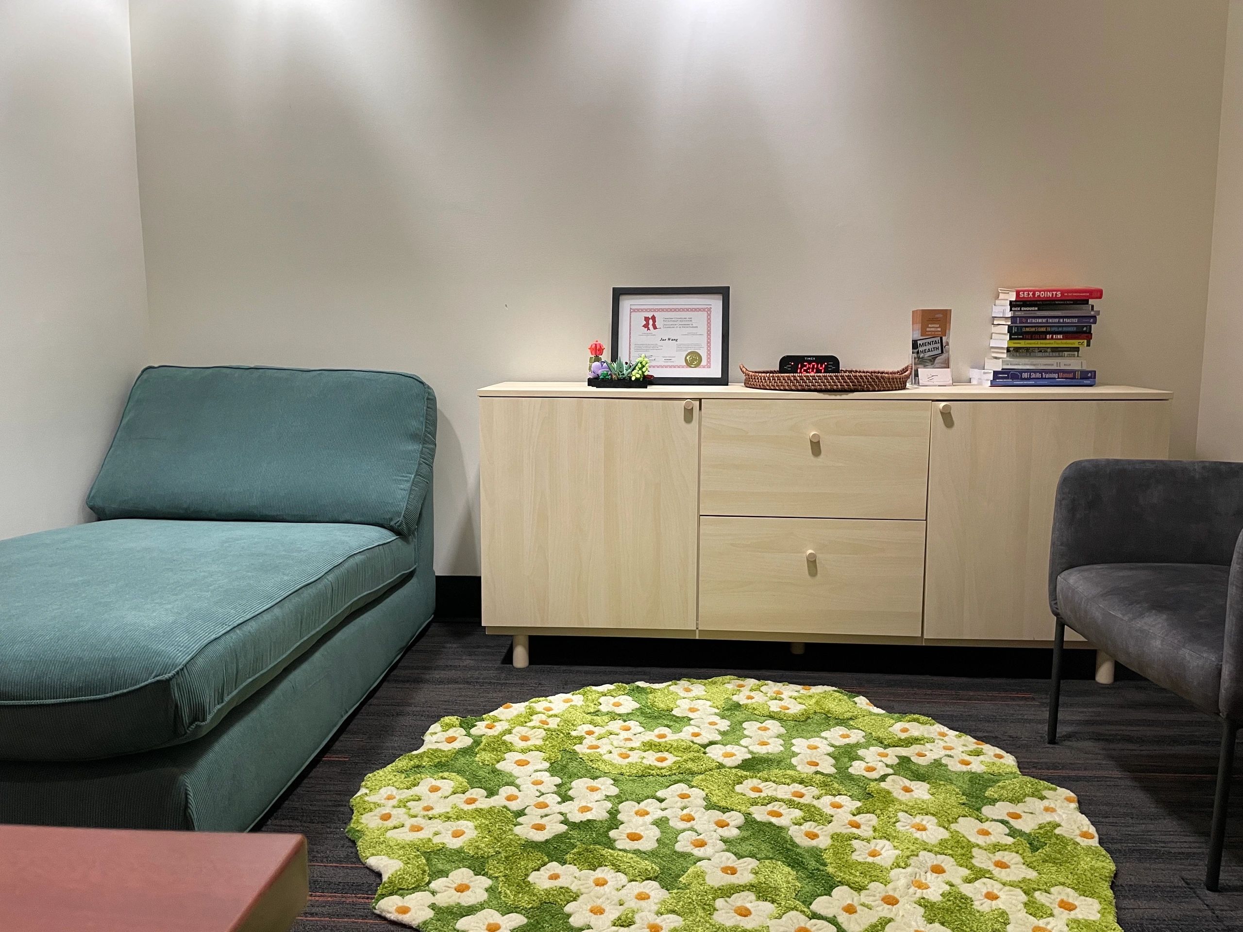 Office with lounging chair (no arms) across to a small individual armed chair. 