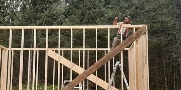 owner Lyle Matthews framing a new cottage, Port Loring