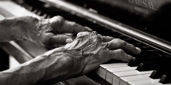 A pair of old lady's hands playing the piano