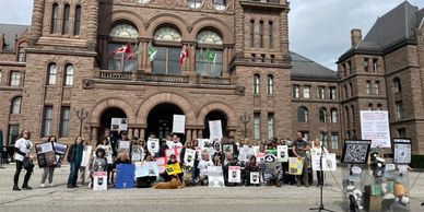 Large group of protesters outside of Queens Park in Toronto