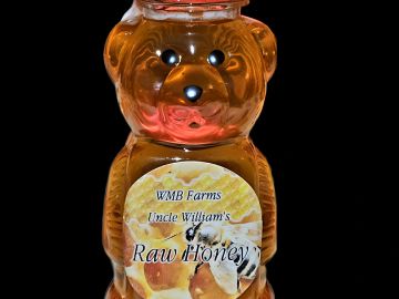 Premium raw wildflower honey in an easy -to - use bear bottle.