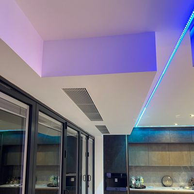 Modern kitchen ceiling with blue LED strip lighting.