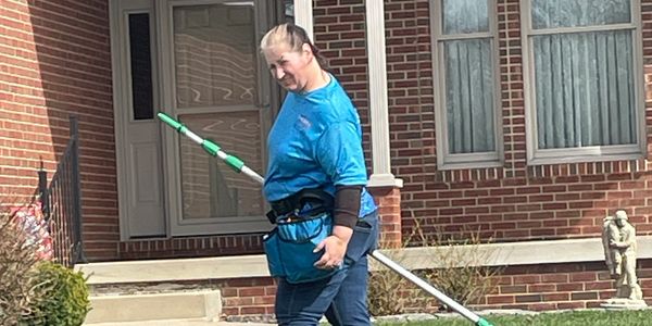 Christina with Curb Appeal Pressure washing heading in to wash windows in Brazil, Indiana