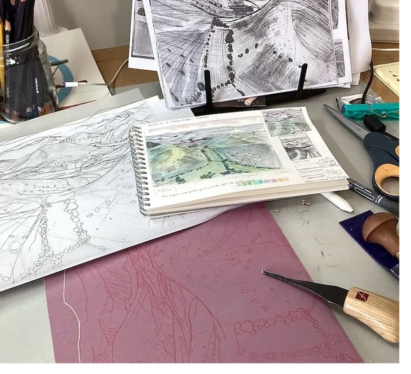 landscape sketches with a lino block stained red and Flexcut cutting tool