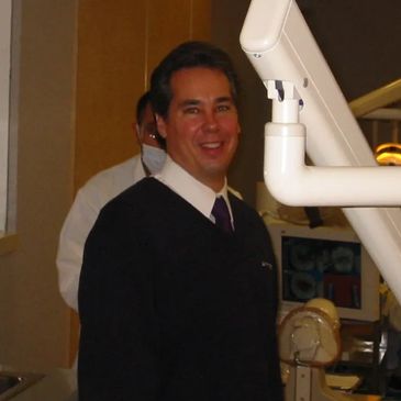 A Man in a Black Color Suit With a Medical Equipment